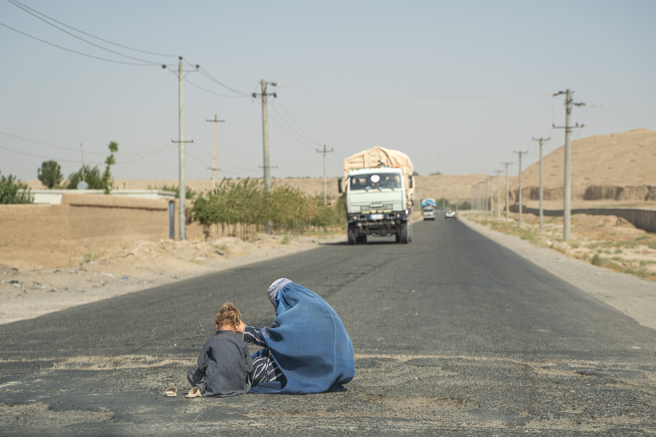 Afghan woman with child on road